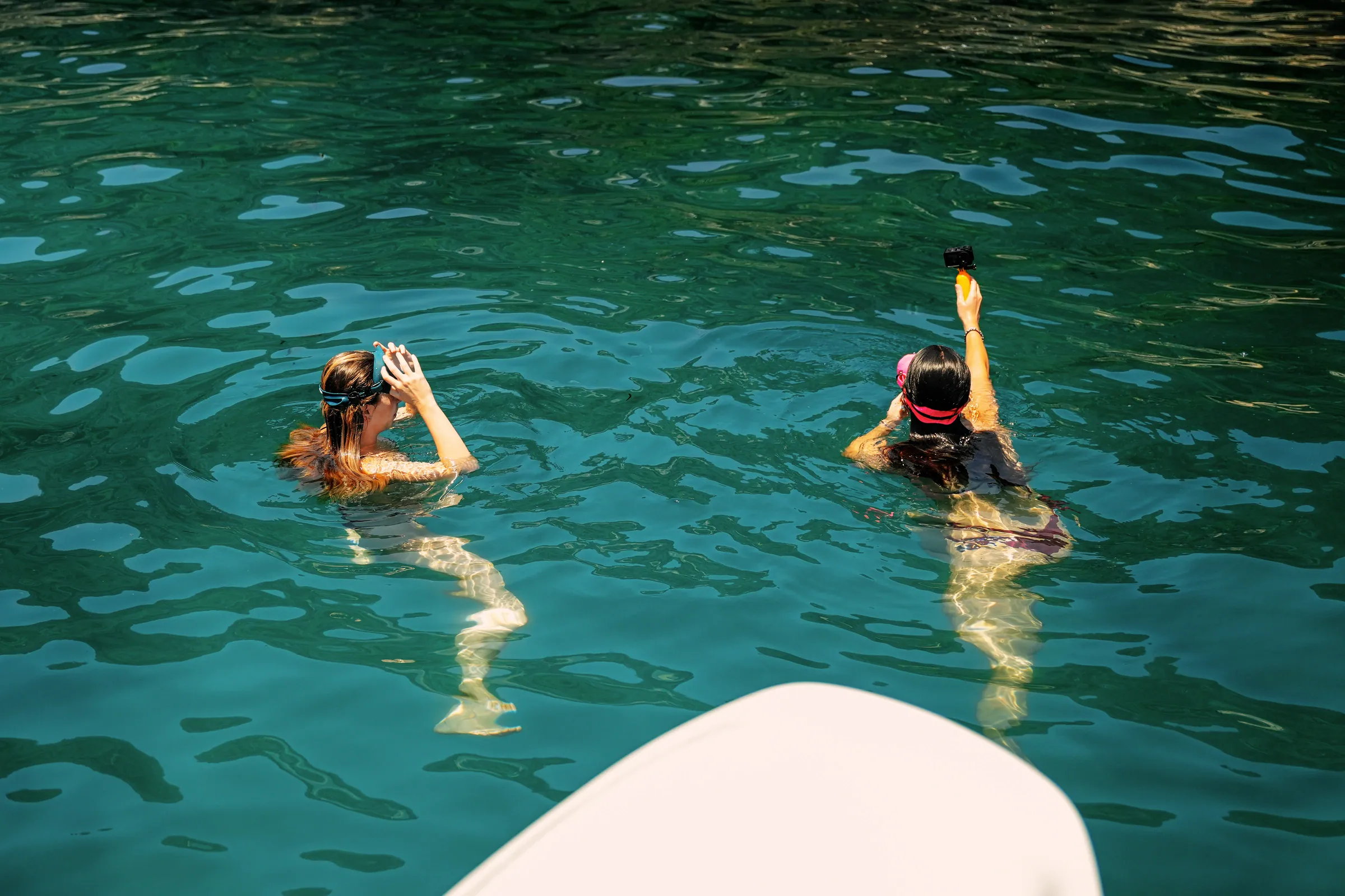 A guest snorkelling in clear water beside Emerald