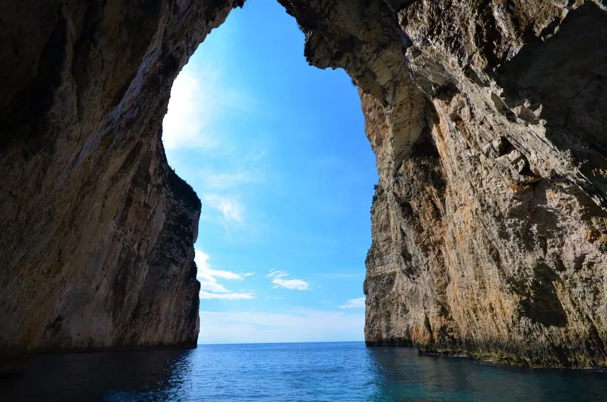 The mouth of a sea cave in the limestone cliffs of Paxos