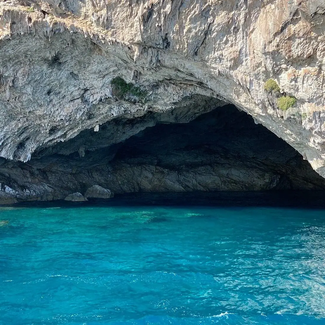 The mouth of the Papanikolis cave in the cliffs near Sivota