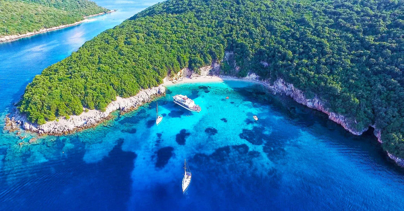 The shallow pale green water of the Blue Lagoon near Sivota