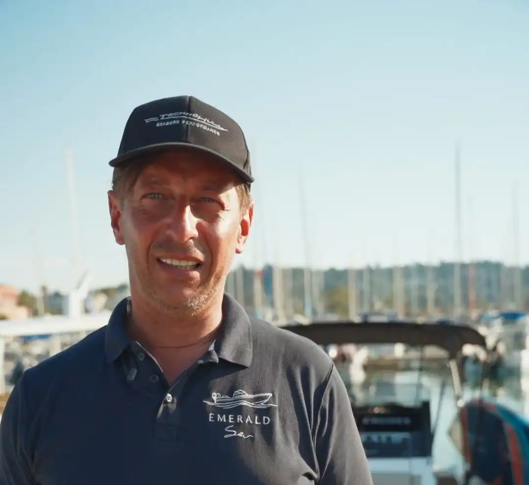 Christos Batralis, Emerald’s skipper, at the marina in an Emerald polo and a Technohull cap
